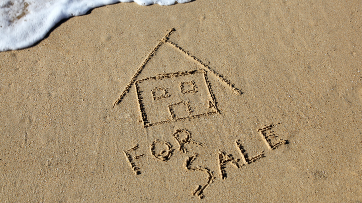 "for sale" written in the sand in Wilton Manors, FL