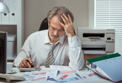 man looking at old bills